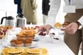 Woman taking snack during coffee break, closeup Royalty Free Stock Photo