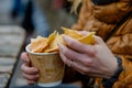 Woman taking snack, low-calorie chips coffee break, light snack in mug closeup, eating food, cute girl portrait Royalty Free Stock Photo