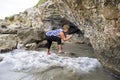 Woman taking snapshots with smartphone on a splendid stony cliff. Royalty Free Stock Photo