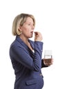 Woman taking tablet with glass of water Royalty Free Stock Photo