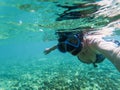 woman taking an underwater selfie while snorkeling in crystal clear tropical water Royalty Free Stock Photo