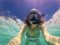 woman taking an underwater selfie while snorkeling in crystal clear tropical water Royalty Free Stock Photo