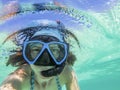 woman taking an underwater selfie while snorkeling in crystal clear tropical water Royalty Free Stock Photo
