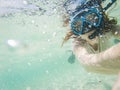 woman taking an underwater selfie while snorkeling in crystal clear tropical water Royalty Free Stock Photo