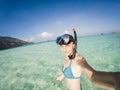 woman taking an underwater selfie while snorkeling in crystal clear tropical water Royalty Free Stock Photo