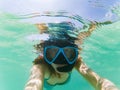 woman taking an underwater selfie while snorkeling in crystal clear tropical water Royalty Free Stock Photo