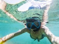 woman taking an underwater selfie while snorkeling in crystal clear tropical water Royalty Free Stock Photo