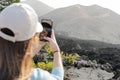 woman taking vertical photo with cell phone and seeing reflection