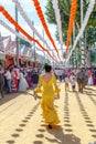 Woman taking a walk and dressed in yellow traditional costumes at the Seville`s April Fair.