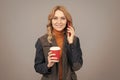 Woman talk on phone drinking coffee. Caffeine and smartphone addiction. Addiction to technology