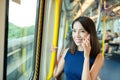 Woman talk to cellphone inside train compartment Royalty Free Stock Photo
