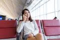Woman talk to mobile phone in the airport Royalty Free Stock Photo