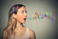 Woman talking alphabet letters in her head coming out of open mouth Royalty Free Stock Photo