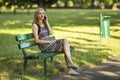 woman talking on cell phone sitting on a bench in the Park Royalty Free Stock Photo