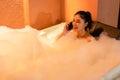 Woman talking with mobile phone in the bathtub at night Royalty Free Stock Photo