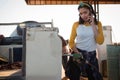 Woman talking on mobile phone while filling petrol in car Royalty Free Stock Photo