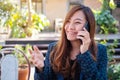 A woman talking on mobile phone with smiling face in the outdoors Royalty Free Stock Photo