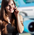 Woman talking by the phone at the airport