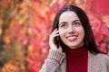 Woman talking on phone in autumn park Royalty Free Stock Photo