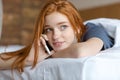 Woman talking on the phone in bed Royalty Free Stock Photo