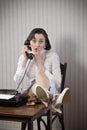 Woman talking on phone at desk Royalty Free Stock Photo