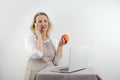 woman talking on phone is upset and displeased in hands she has red apple dietetics proper nutrition menu recipes in Royalty Free Stock Photo