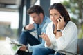 woman talking on phone while waiting for bus at busstop