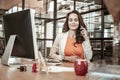 Smiling appealing long-haired woman having conversation on mobile phone Royalty Free Stock Photo