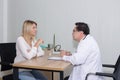 Woman talking to doctor psychiatrist in hospital