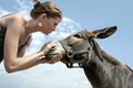 Woman talking to donkey