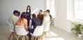 Woman talking to group of young diverse business people during meeting in office Royalty Free Stock Photo