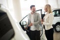 Woman is talking to handsome car dealership worker while choosing a car Royalty Free Stock Photo