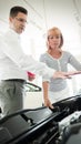 Woman is talking to handsome car dealership worker while choosing a car Royalty Free Stock Photo