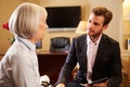 Woman Talking To Male Counsellor Using Digital Tab Royalty Free Stock Photo