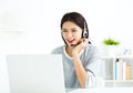 woman talking in video call on line with headsets and laptop