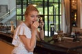 Woman talking on a vintage phone. the girl tells a secret. gossip girl secretly with her friend
