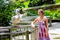 Woman talks to pelican in the bird park