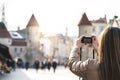 Woman in Tallinn taking photo of Viru Gate. Royalty Free Stock Photo