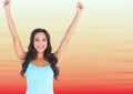 Woman in tank top celebrating against blurry red and peach background Royalty Free Stock Photo