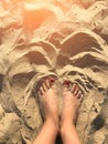 Woman tanned legs on sand beach. Travel concept. Happy feet in tropical paradise