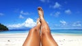 Woman tanned skin legs on the beach. Royalty Free Stock Photo