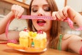 Woman with tape measure and cake. Diet dilemma. Royalty Free Stock Photo