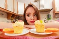 Woman with tape measure and cake. Diet dilemma. Royalty Free Stock Photo