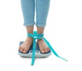 Woman with tape measuring her weight Royalty Free Stock Photo