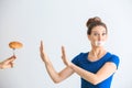 Woman with taped mouth refusing to eat unhealthy food on white background. Diet concept Royalty Free Stock Photo