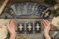 Woman with tarot cards at wooden table, top view. Reverse side Royalty Free Stock Photo