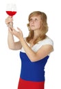 Woman - taster checks color and opacity of wine