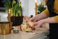 Woman tasting Easter cake, preparing Easter basket with embroidered towel Royalty Free Stock Photo