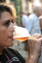 Woman tasting a glass of white sparklig wine. Color image