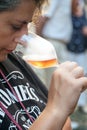 Woman tasting a glass of white sparklig wine. Color image